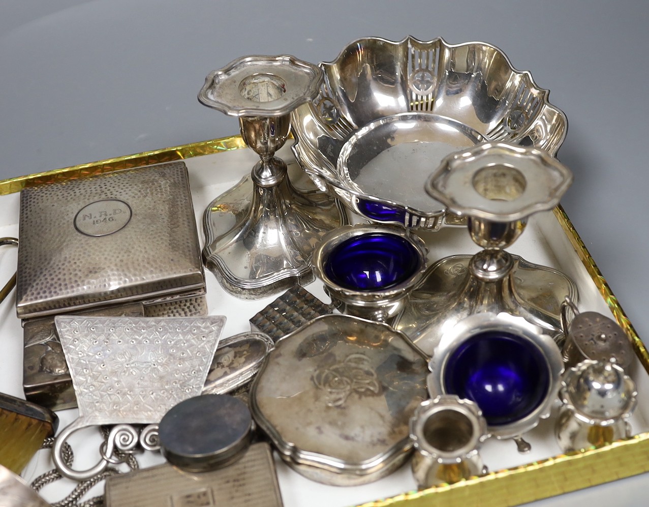 Assorted silver including a pierced bowl, pair of dwarf candlesticks, four condiments(a.f.), cigarette box, lid, 19th century snuff box and vinaigrette, match sleeve oval pill box, oval pepperette with handle and modern